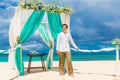 Wedding ceremony on a tropical beach in blue.The groom waits for Royalty Free Stock Photo