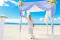 Wedding ceremony on a tropical beach in blue.The groom waits for Royalty Free Stock Photo