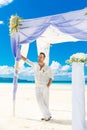 Wedding ceremony on a tropical beach in blue.The groom waits for Royalty Free Stock Photo