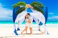 Wedding ceremony on a tropical beach in blue. Happy groom and bride Royalty Free Stock Photo