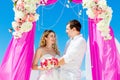 Wedding ceremony on a tropical beach in purple. Happy groom and Royalty Free Stock Photo