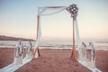 Wedding ceremony on a tropical beach in white. Arch decorated with flowers on the sandy beach, wedding concept Royalty Free Stock Photo