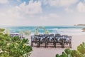 Beautiful beach wedding venue setting with flowers decoration on arch, panoramic ocean view Royalty Free Stock Photo