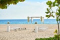 Beautiful beach wedding venue setting with flowers decoration, panoramic ocean view