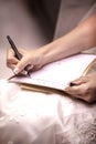 Bride to be writing her vows to her husband to be before the wedding ceremony Royalty Free Stock Photo