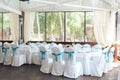 Wedding chair decoration. wedding celebration party decoration white cover chair with blue lace ribbon