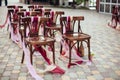 Wedding chairs with tapes,wedding ceremony in outside.rustik style. White door arch in green tree background. Royalty Free Stock Photo