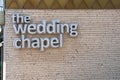 The Wedding Chapel sign on the outside of a brick building