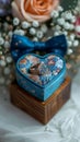 Wedding charm rings in wooden box on flower filled heart stand