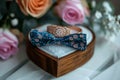 Wedding charm rings in wooden box on flower filled heart stand Royalty Free Stock Photo