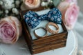 Wedding charm rings in wooden box on flower filled heart stand