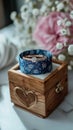 Wedding charm rings in wooden box on flower filled heart stand