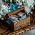 Wedding charm rings in wooden box on flower filled heart stand Royalty Free Stock Photo