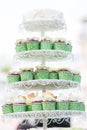 Wedding chocolate Cupcakes in green cup with garland lights bokeh and sunlight background