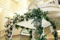 Wedding chuppah decorated with fresh flowers indoor banquet hall of wedding ceremony. Luxury wedding florist decoration artwork