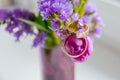 Wedding concept: bouquet of pink,purple tulips and two golden rings.Flowering branch with purple, violet flowers on Royalty Free Stock Photo