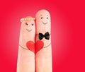Wedding concept, newlyweds with heart against red background