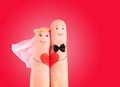 Wedding concept, newlyweds with heart against red background