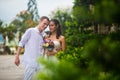 Wedding couple, a beautiful young bride and groom, are standing in the Park outdoors, embracing and and smiling Royalty Free Stock Photo