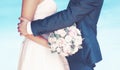 Wedding couple, bouquet of peonies flowers, groom hugs lovely bride