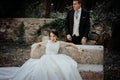 Wedding couple. The bride is sitting. The groom stands Royalty Free Stock Photo