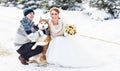 Wedding couple and a cute dog in winter time Royalty Free Stock Photo