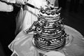 Wedding couple is cutting modern rustic cake. Open sponge dessert with mint leaves and fresh fruit grapes on top. Boho style Royalty Free Stock Photo