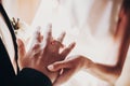 Wedding couple exchanging wedding rings during holy matrimony in church. Bride and groom putting golden rings on finger, close up Royalty Free Stock Photo