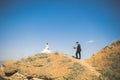 Wedding couple, groom, bride with bouquet posing near sea and blue sky Royalty Free Stock Photo