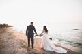 Wedding couple, groom, bride with bouquet posing near sea and blue sky Royalty Free Stock Photo