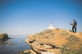 Wedding couple, groom, bride with bouquet posing near sea and blue sky Royalty Free Stock Photo