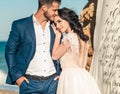 Wedding couple, groom and bride in wedding dress near the sea at the seaside Royalty Free Stock Photo