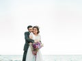 Wedding couple, groom and bride in wedding dress near the sea at the seaside Royalty Free Stock Photo