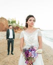 Wedding couple, groom and bride in wedding dress near the sea at the seaside Royalty Free Stock Photo