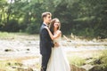 Wedding couple, groom and bride hugging, outdoor near river Royalty Free Stock Photo