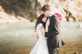 Wedding couple, groom and bride hugging, outdoor near river