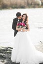 Wedding couple, groom and bride hugging, outdoor near river