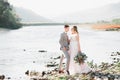 Wedding couple, groom and bride hugging, outdoor near river Royalty Free Stock Photo