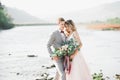 Wedding couple, groom and bride hugging, outdoor near river