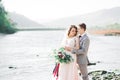 Wedding couple, groom and bride hugging, outdoor near river Royalty Free Stock Photo