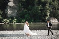 Wedding couple, groom and bride running, outdoor near river Royalty Free Stock Photo