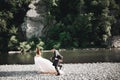 Wedding couple, groom and bride running, outdoor near river Royalty Free Stock Photo