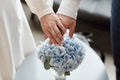 Wedding couple holding hands above wedding bouquet. Love and marriage concept Royalty Free Stock Photo