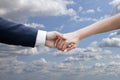 Wedding couple holding hands on blue sky with clouds Royalty Free Stock Photo