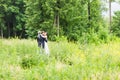 Wedding couple hugging, the bride holding a bouquet of flowers, groom embracing her Royalty Free Stock Photo