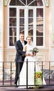 Wedding couple hugging, bride holding a bouquet of flowers, the groom embracing her Royalty Free Stock Photo