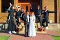 Wedding Couple And Jumping Groom`s Friends