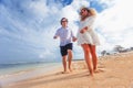 Wedding couple just married holds hands and walking at beach Royalty Free Stock Photo