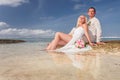 Wedding couple just married lying at water near the beach Royalty Free Stock Photo