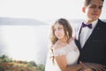 Wedding couple kissing and hugging on rocks near blue sea Royalty Free Stock Photo